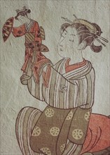 The courtesan Hatsuito playing with a doll