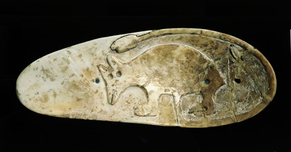 Sandal sole gorget decorated in relief with a strange animal with the umbilical cord still attached