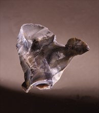 Quartzite flint, may have been modified to suggest the form of a mans head