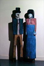 Painted wood carvings of man and woman in European dress