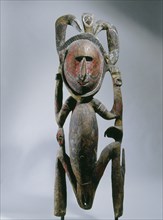 Squatting female clan spirit figure with two hornbills, from a Maprik region mens society meeting house