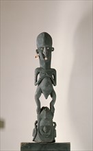 Female figure standing on a mask, Sepik area, probably a depiction of a clan spirit from a mens meeting house