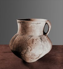 Jug with broad handle and insiced decoration