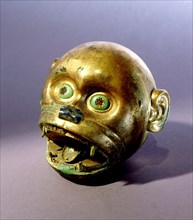 Gold monkey head bead which is typical of the elaborate funerary goods buried with Mochica nobility