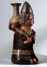 An effigy ceramic showing a male figure carrying the Inca aryballus on his back