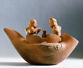 Hollow effigy jar depicting two Mochica fisherman sitting on a reed raft