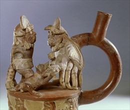 Mochica, stirrup spouted jar showing an scene from mythology in which a fanged deity accompanied by a dog confronts a crab monster