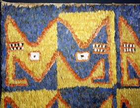 Featherwork tabbard with dragon head motif