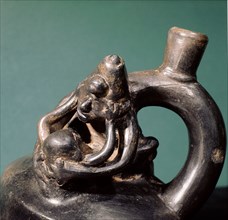 Stirrup spouted vessel depicting  copulating couple