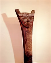 House post with decoration of stylized face