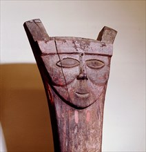 House post with decoration of stylized face