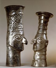 Two ritual drinking vessels which portray distinctive Chimu features,particularly the wide eyes and prominent nose