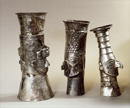 Three ritual drinking vessels which portray distinctive Chimu features, particularly the wide eyes and prominent nose