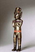 Male figurine cast in silver with unusual inlay of gold, stone and pink shell