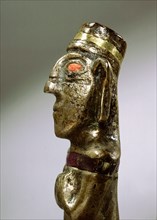 Male figurine cast in silver with unusual inlay of gold, stone and pink shell