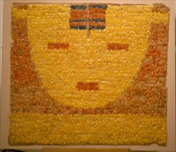 Featherwork tabbard depicting a serene sun face, or sun in repose, the personification of the sun god Inti