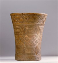 This Andean kero or ritual drinking vessel is decorated with Inca geometric designs