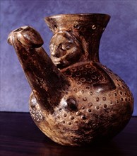 A jug or vase with a spout in the form of a phallus