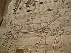 Relief on the reverse side of the First Pylon depicting priestes carrying the saccred barque of Isis