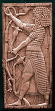 Fragment showing a warrior in ceremonial dress holding a lily