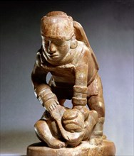 Soapstone pipe generally assumed to depict a warrior beheading his victim