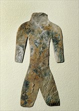 Silhouette of a mutilated human figure cut from a thin sheet of mica