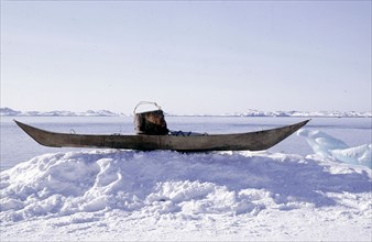 Kayak with a sealskin vest projecting up from the coaming