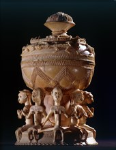 Ivory salt cellar carved in Sierra Leone for sale to Portuguese traders, depicting four male and four female figures wearing items of European dress