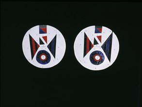 Pair of earrings made from coloured pieces of linoleum attached to a wooden disc