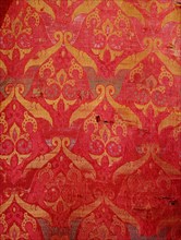 A detail of a red and gold silk weaving from Granada