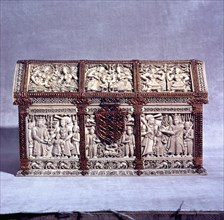 A casket decorated with rubies, gold and sapphires which shows the crowning of a boy prince