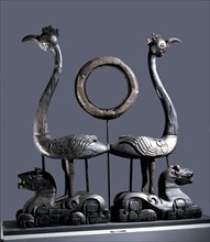 Sculpture of a pair of phoenixes resting on reclining tigers
