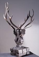 Wooden sculpture of mythical being with deer antlers