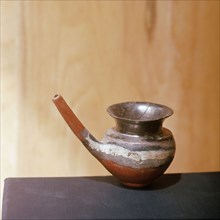Small vessell with elongated pouring spout