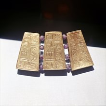 Fragment of Nubian jewellery, with gold panels incised with Egyptian hieroglyphs, including royal names