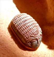 Green glazed steatite scarab with human face, found at the Nubian town of Kerma