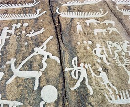 Petroglyphs with human figures hunting