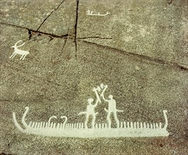 Petroglyph depicting phallic figures on board a ship, apparently performing a ceremonial axe dance