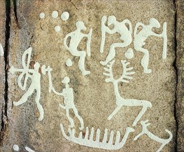Petroglyphs; figures brandishing weapons, with a reindeer
