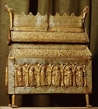 Brass reliquary with incised decoration and repousse panels depicting saints