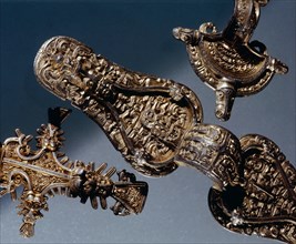 Brooches richly decorated with animals, human beings and gilt details