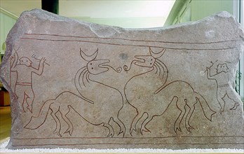 Limestone stele incised with designof hunters and dragons