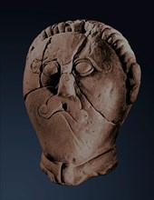 Male head in the La Tene style, found within a sacred enclosure and referred to as a warrior or a Celtic deity