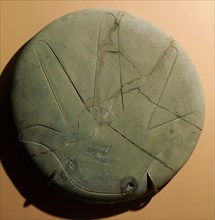 Stone disc engraved with a hand