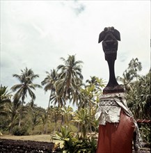 Figure of a god mounted on a pillar in the walled enclosure of the Marae Attahooroo, Tahiti