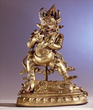 Ekavira Bharavara, the bull headed deity tramples on a demon lying face down on the back of a prostrated bull having a dakini engraved on its rump