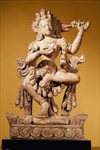Vajravarahi dancing naked on her toes holding a kartrika knife in her right hand and a skull cup in her left