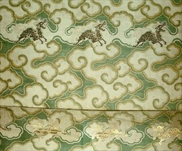Silk brocade with a pattern of silver clouds and gold mythical Chinese unicorns called chi lin or in Japanese, kirin