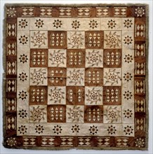 Decorated rug made of animal skin squares