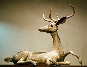 A carving of a resting deer